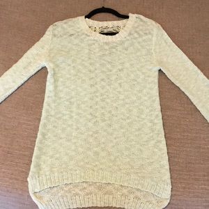 Teal poof sweater with open design in back